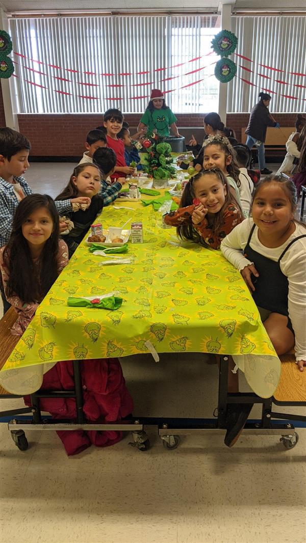 Students dress up and get served a fine meal. 